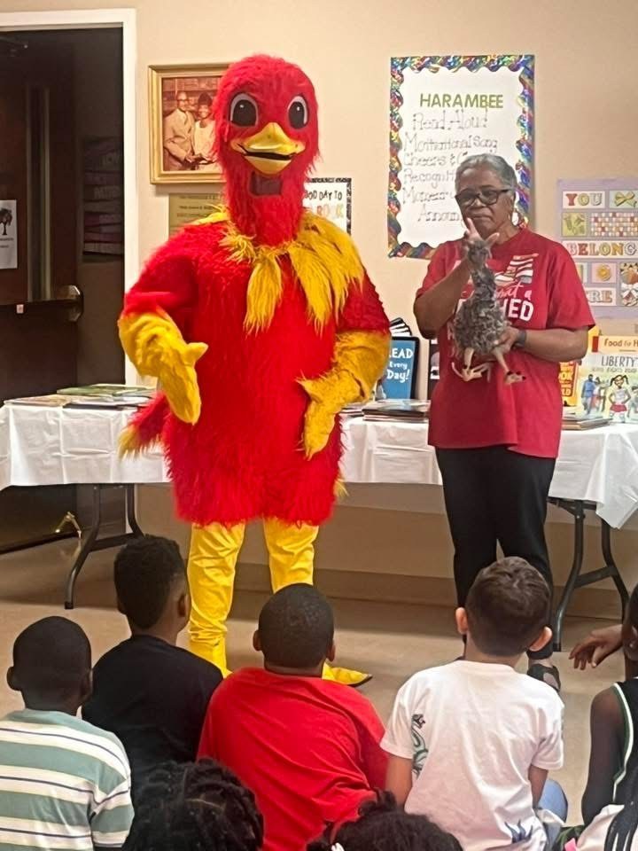 Earl the Emu visiting with children at a reading event